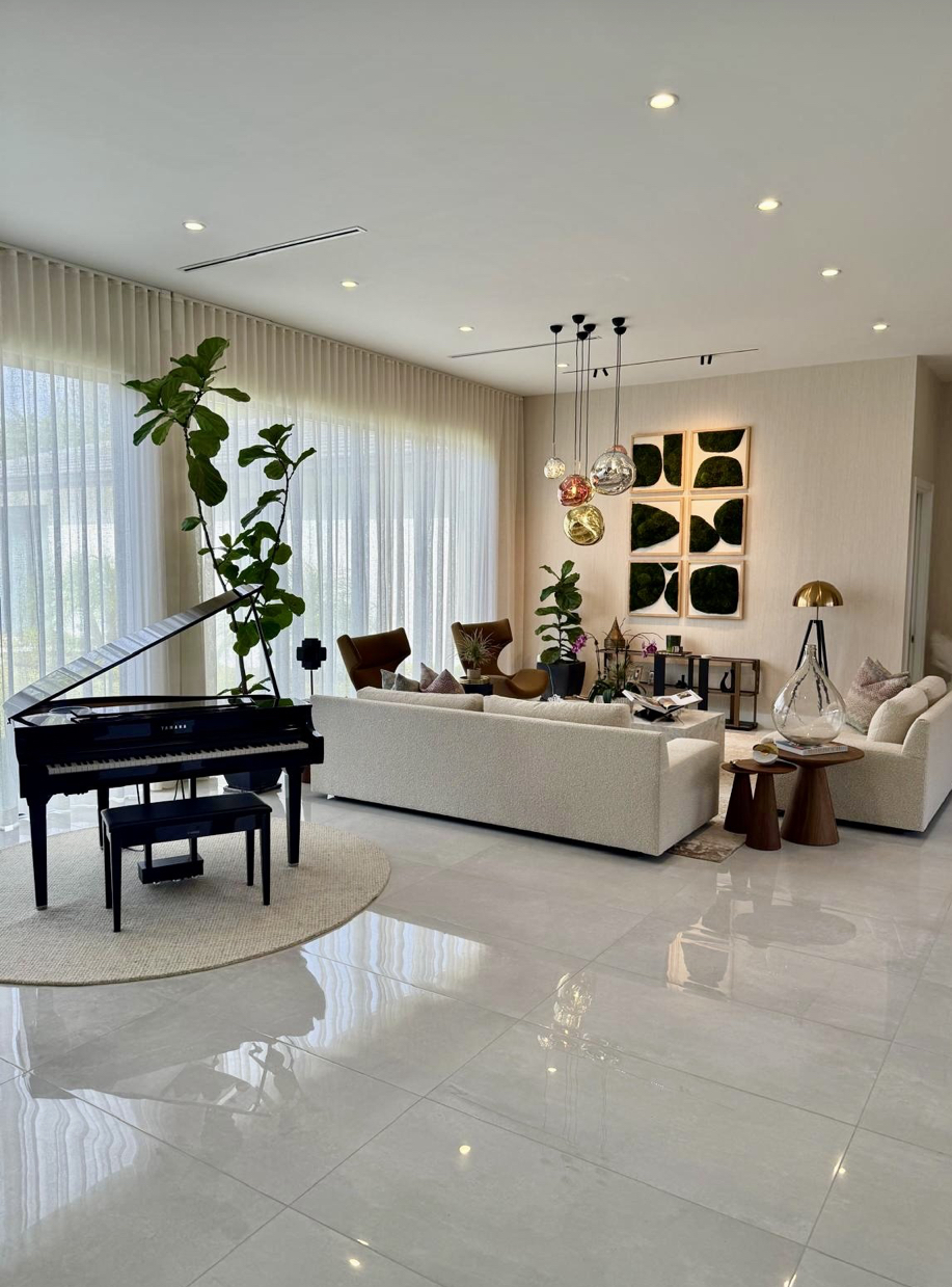 Luxury living room with piano by AR Interiors